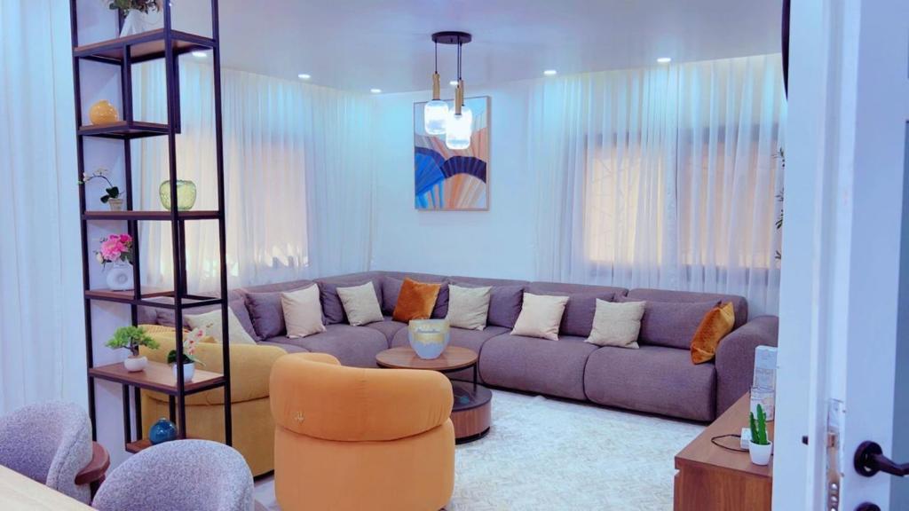 a living room with a couch and a chair at Yadal Home in Darou Rhamane