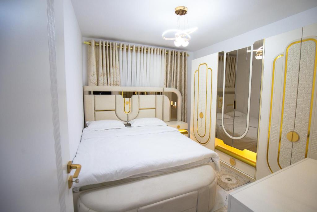 a small bedroom with a bed and a shower at Golden Apartment Korce in Korçë