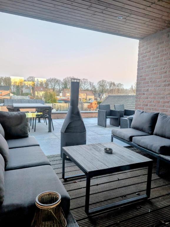 a living room with couches and a coffee table at Duplex appartement 'De Wijers' met 3 slaapkamers in Genk