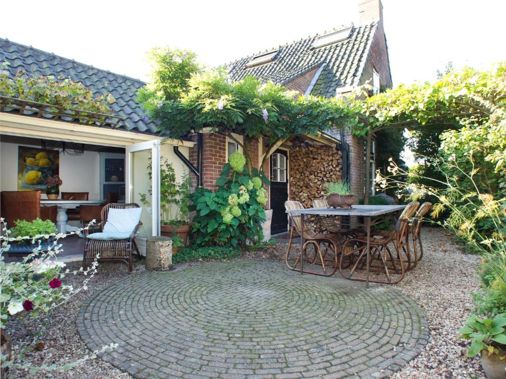 a patio with a table and chairs in a yard at Hövell in Huizen