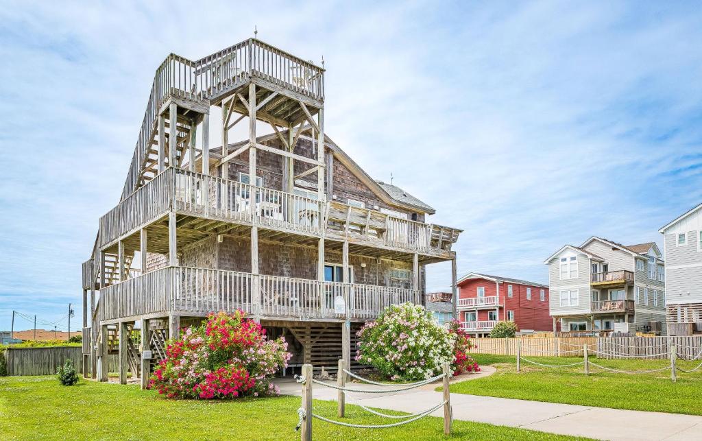 a large wooden house with balconies and flowers at This is it - Nags Head MP 16, Ocean View, 75 Yards to Beach, Elevator, Wheelchair Friendly, Flex Stays in Nags Head