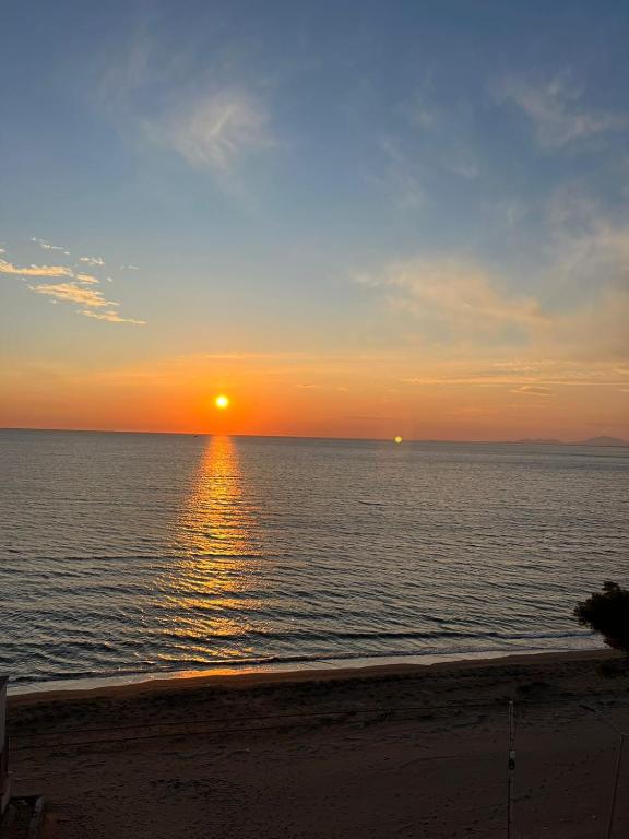 a sunset over the ocean with the sun setting at Shengjini holiday home beautiful in Lezhë