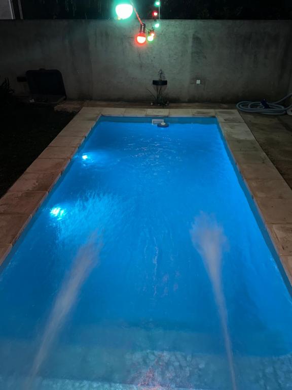 a large blue swimming pool at night at Casa quinta in Dolores