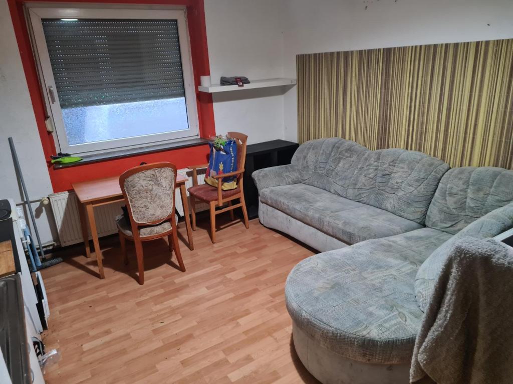 a living room with a couch and a table at MonteurRoomMR in Essen