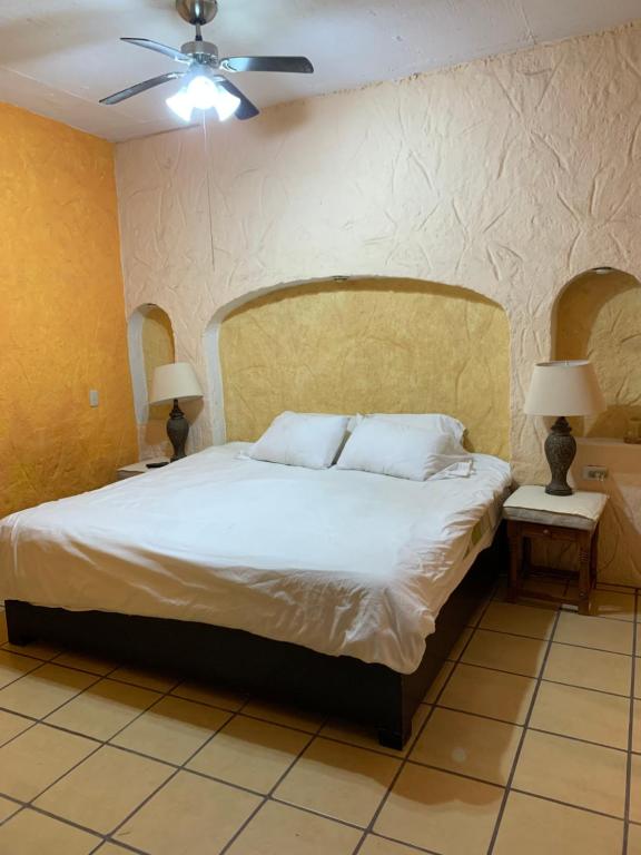 a bedroom with a bed and two night stands with lamps at Casa Díaz in San Miguel de Allende