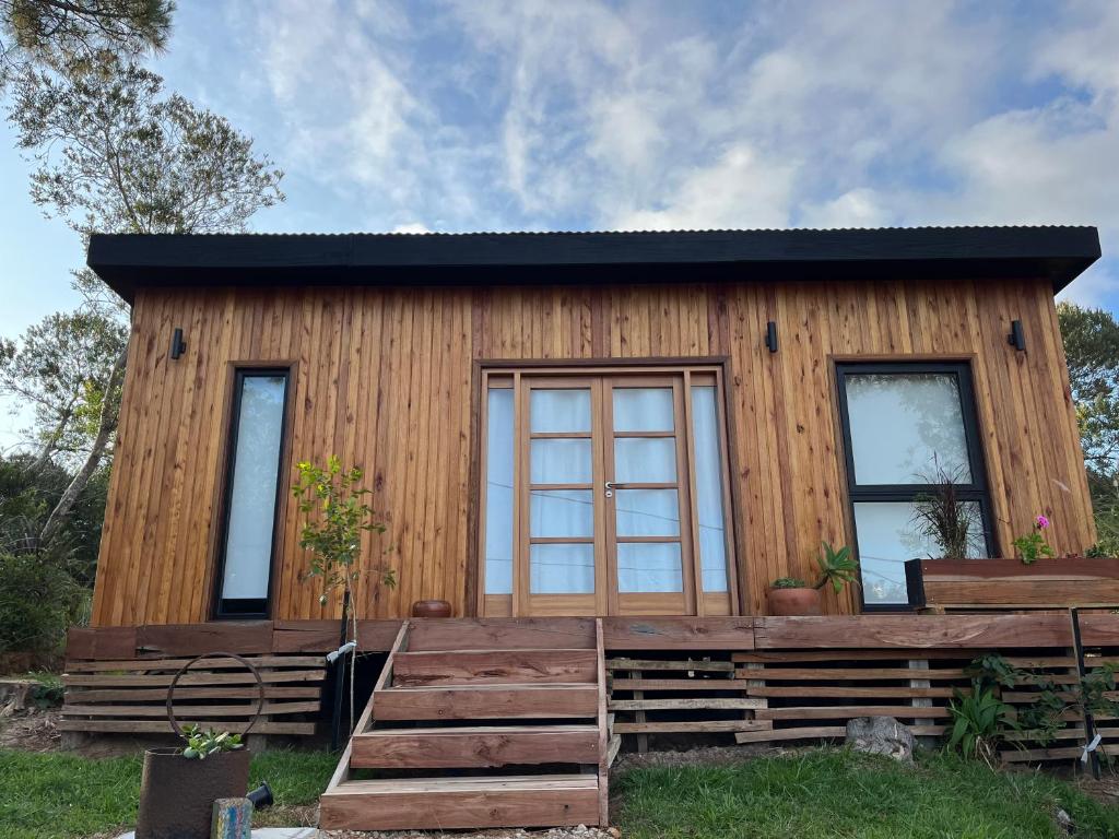 a log cabin with a large window at Mar de Fondo in La Pedrera