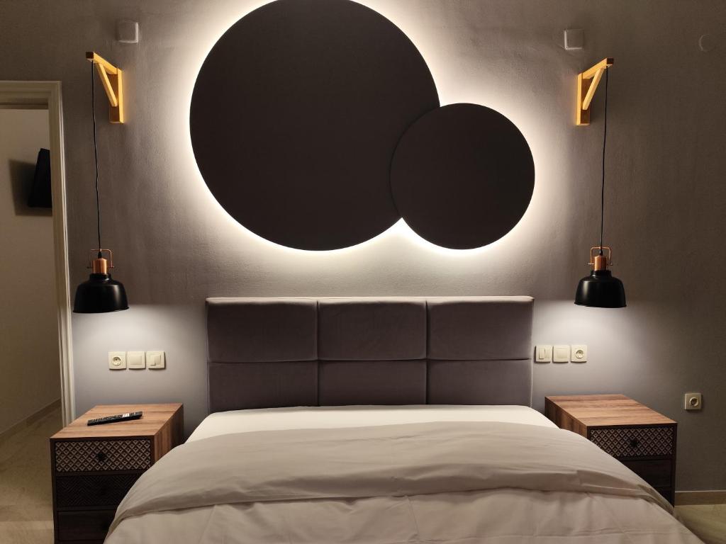 a bedroom with a bed with two lights on the wall at Urban Mountain House in Karpenision