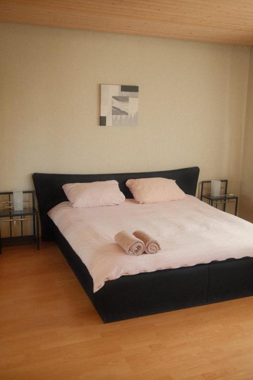 a bedroom with a bed with two towels on it at Pension am Waldrand in Sinsheim