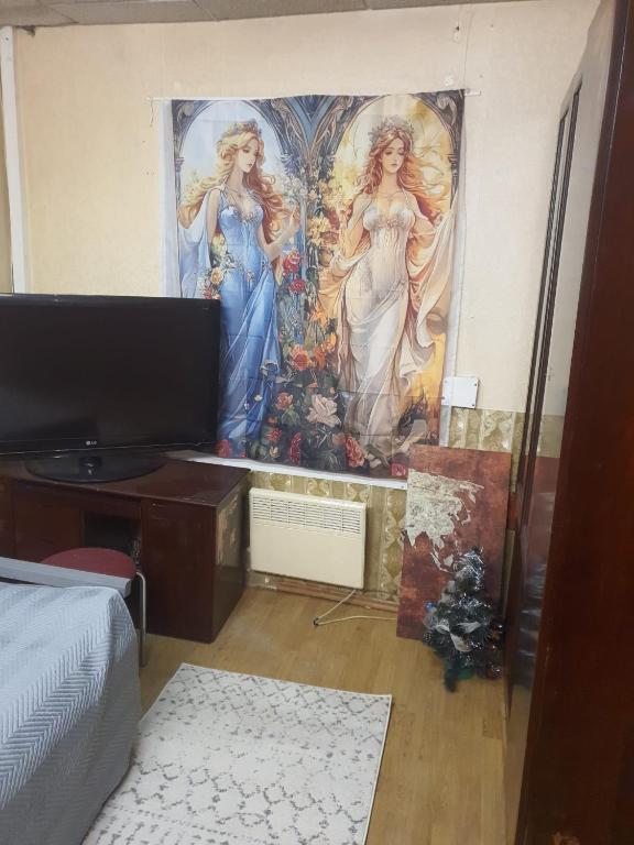 a mural of two women on a wall in a room at Ofiss 24 in Riga