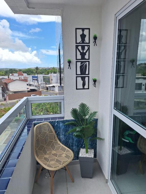 a balcony with a chair and a plant at Pedacinho de Lar in João Pessoa