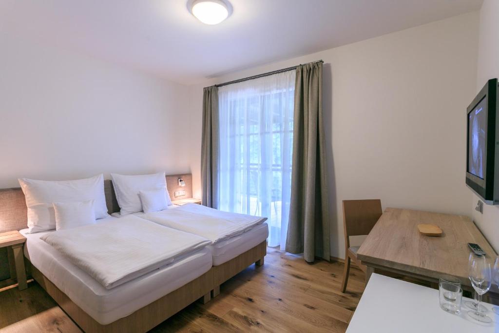 Postel nebo postele na pokoji v ubytování Hotel a restaurace U Vychopňů