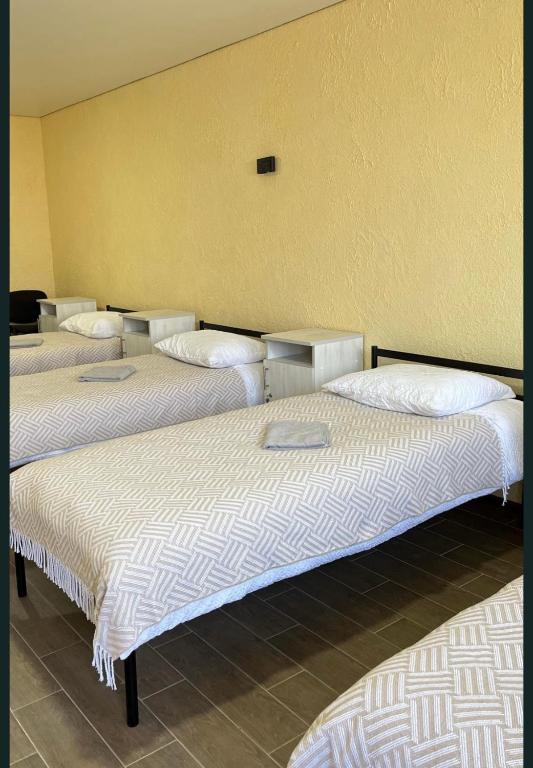 a group of four beds in a room at Hostel Гайсин in Haysyn