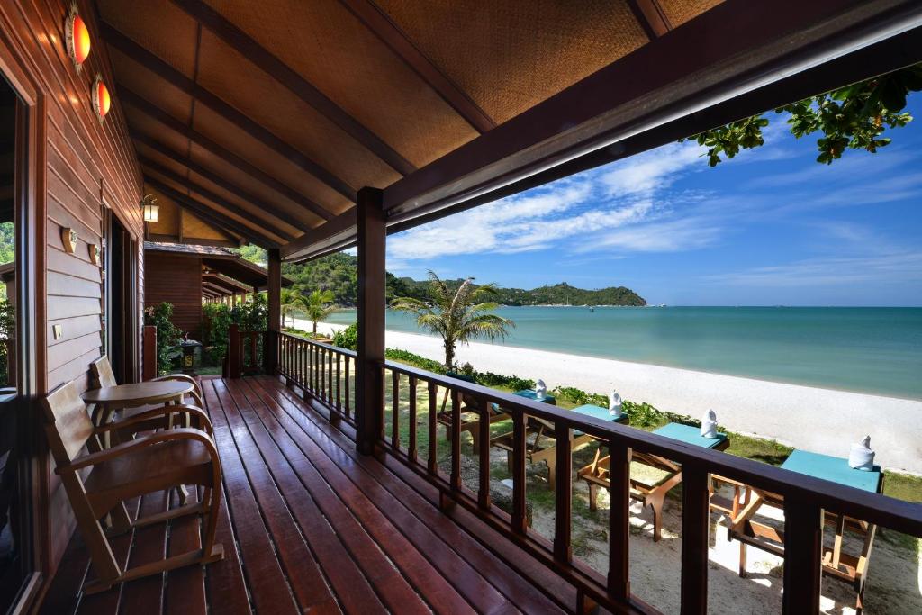 a balcony of a house with a view of the beach at PingChan Koh Phangan Beachfront Resort in Thong Nai Pan Yai