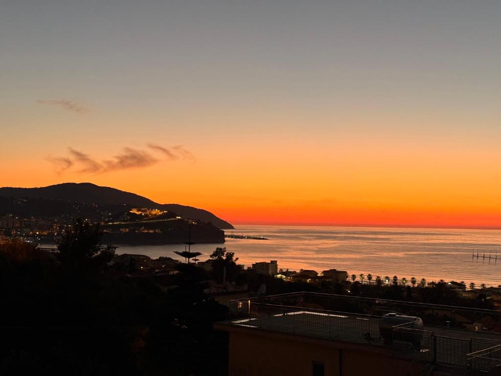 a sunset view of the ocean and a city at Supramonte Guesthouse in Agropoli
