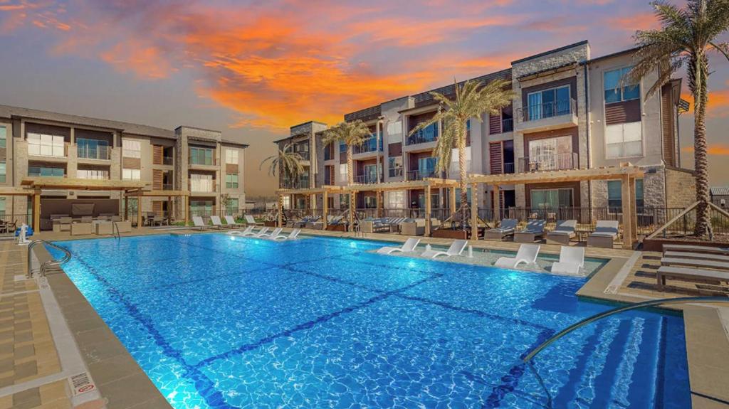 a large swimming pool in front of a building at Landing Beautiful 2BD Pool Yoga Studio in Austin