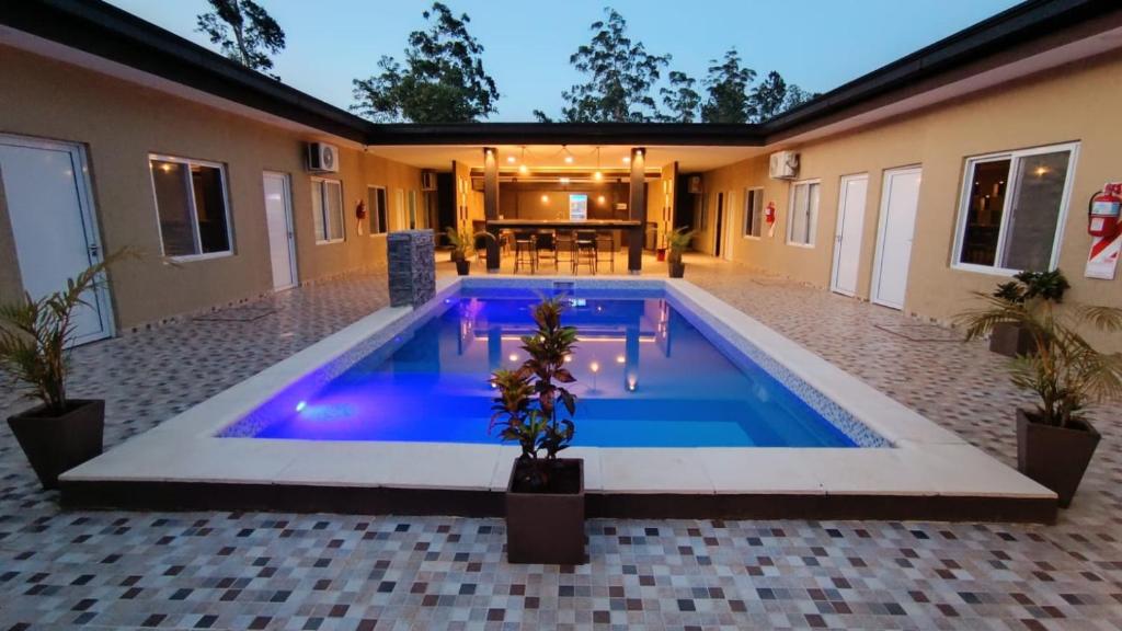 a swimming pool in the middle of a house at Hotel Boutique Porá Iguazú in Puerto Iguazú