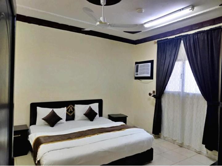 a bedroom with a large bed and a window at شقة مفروشة بتبوك in Tabuk