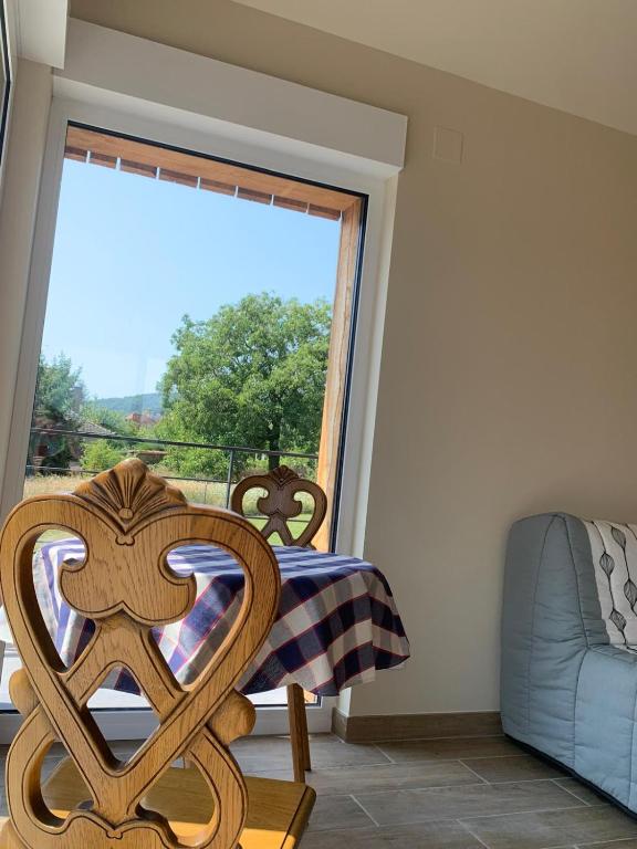a bedroom with a bed and a large window at Le chalet O'Perché - Wissembourg in Wissembourg
