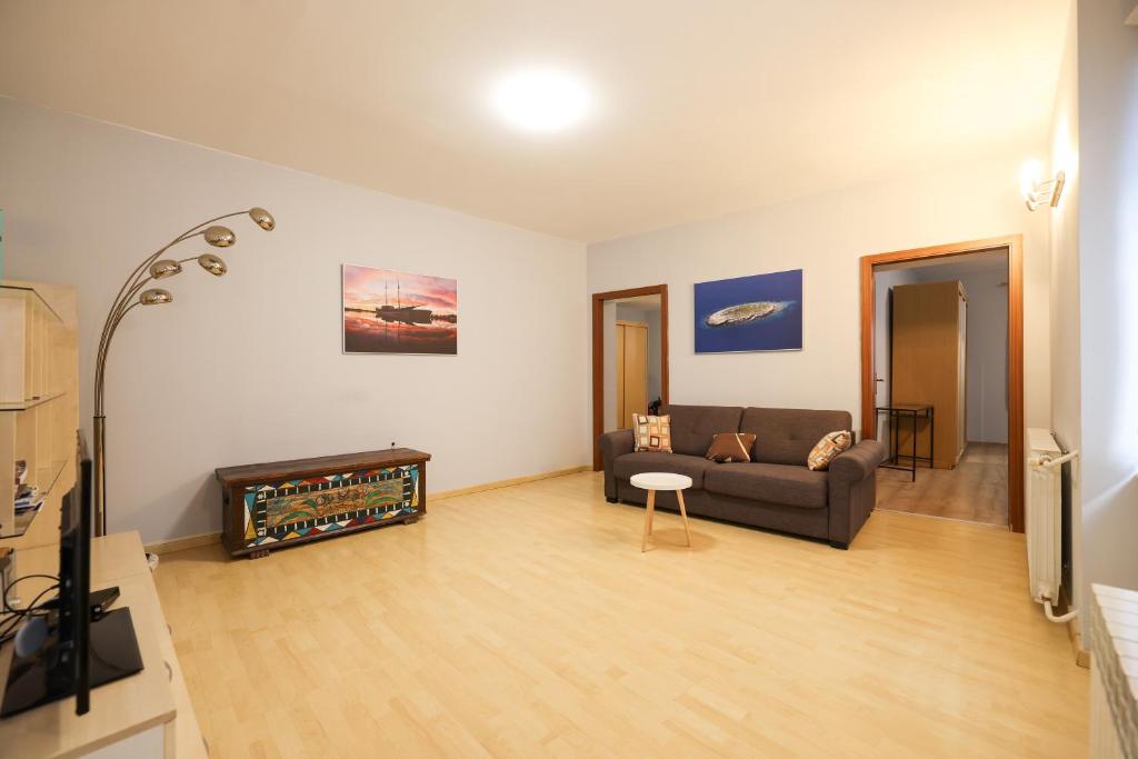 a living room with a couch and a fireplace at Quattro Cantoni Apartment in Zadar