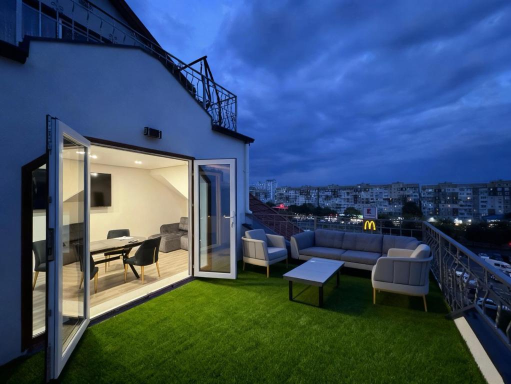 a balcony with a couch and a table on a building at Royal Boulevard Terrace Residence in Chişinău