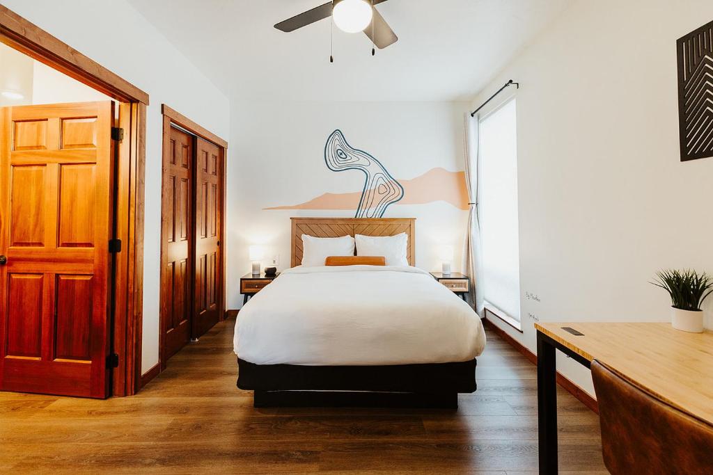 a bedroom with a large bed and a wooden door at Big Mountain Suite Near Logan Health in Kalispell