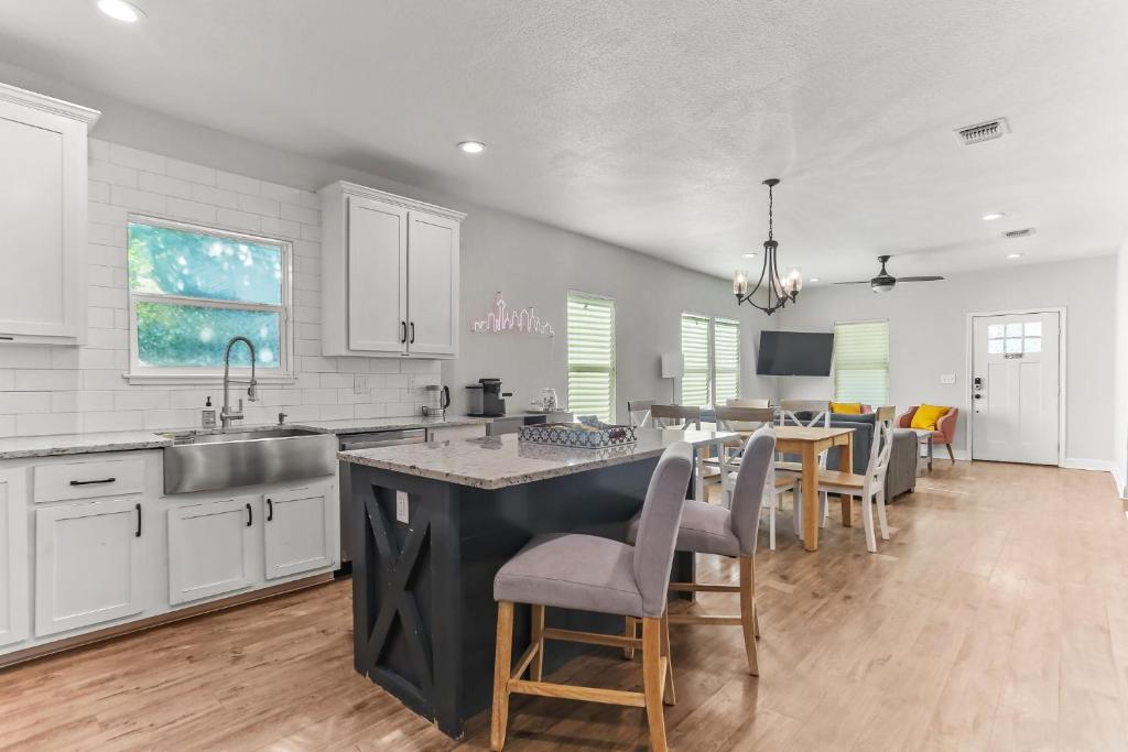 a kitchen with a sink and a table with chairs at Lone Star Landing in San Antonio