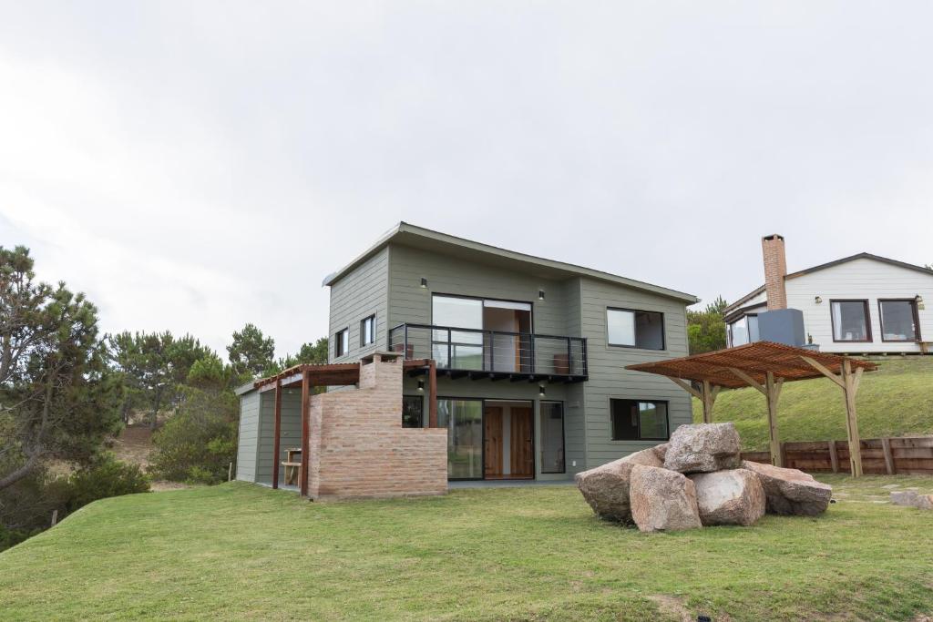 a house on a hill with two large rocks at Orion in Punta Del Diablo