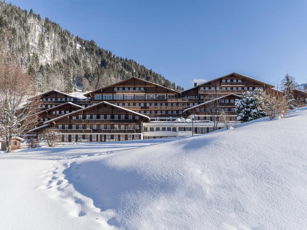 a lodge in the snow in the mountains at HUUS Gstaad in Gstaad