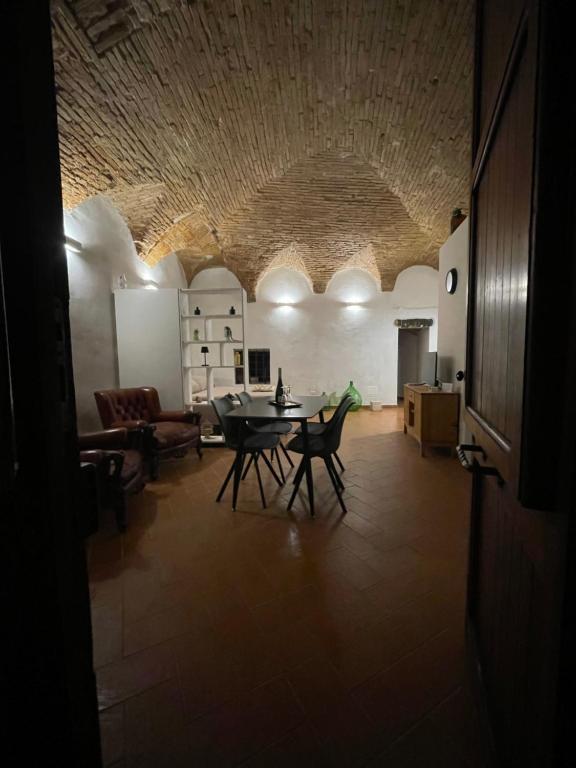 a large living room with a table and chairs at Casa "La Fonte" in Spoleto