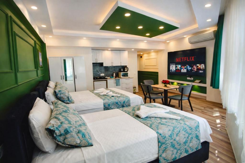 a hotel room with two beds and a kitchen at Valentina Apart Hotel in Istanbul