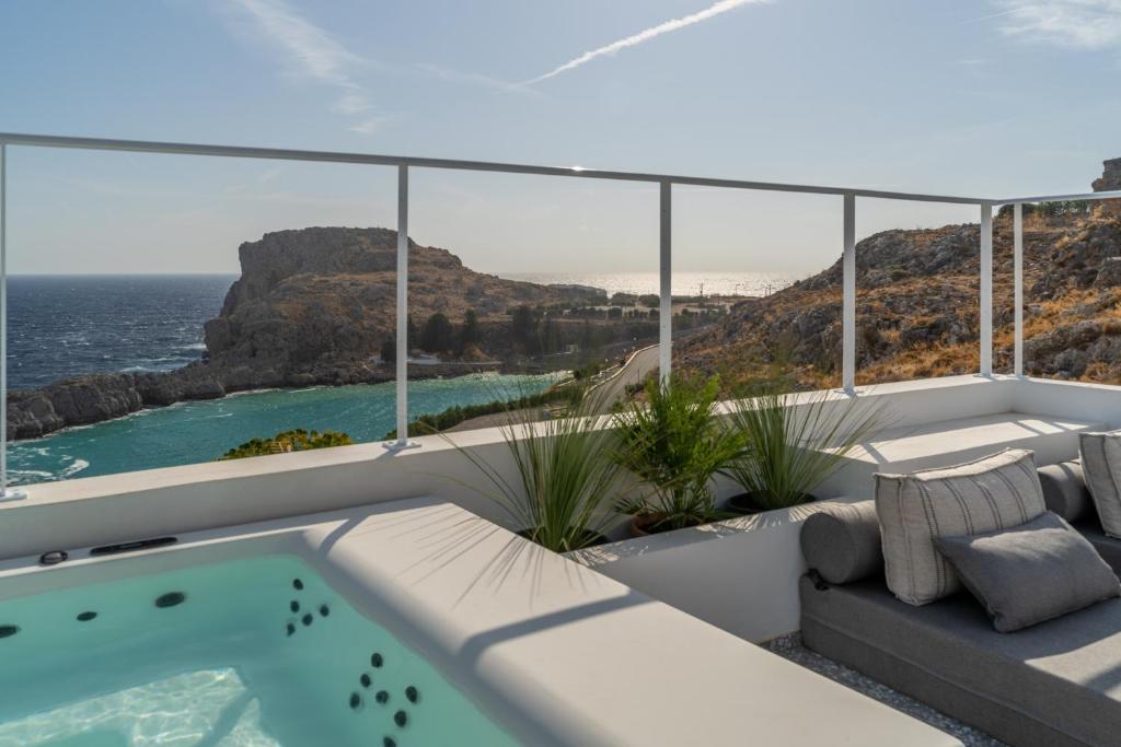 a view of the ocean from the balcony of a house at Lindos 4 me Villa in Lindos