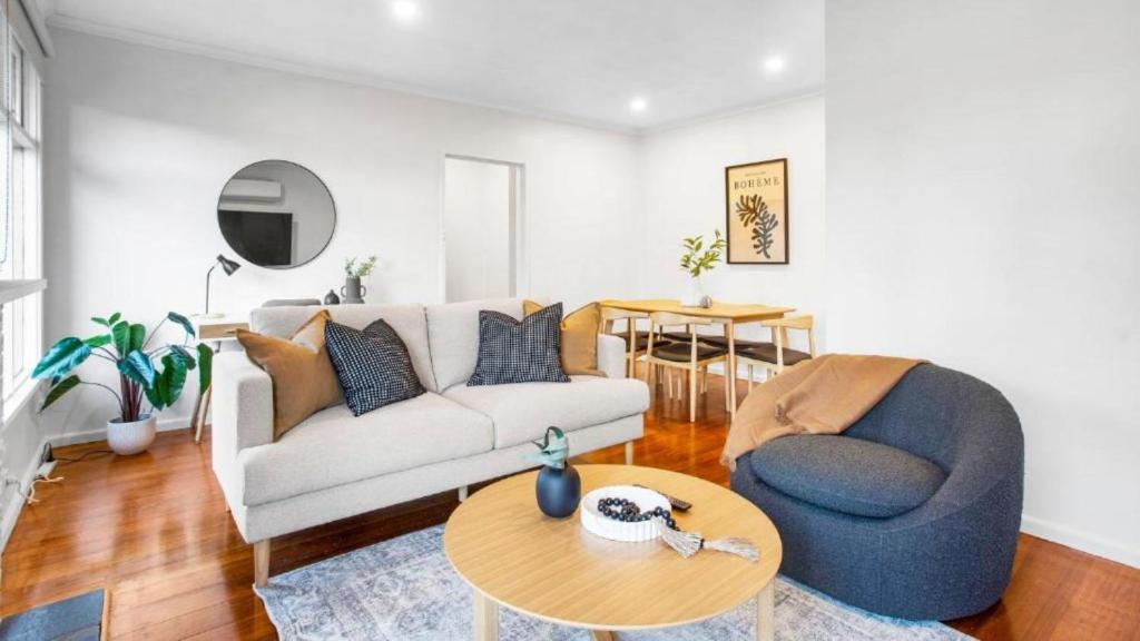 a living room with a couch and a table at Sunnybank House with EV Charger in Cheltenham