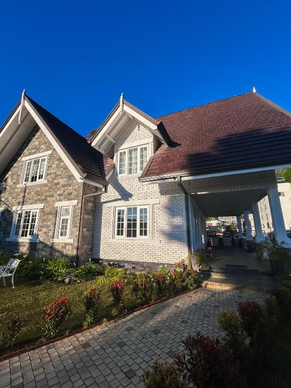 a large house with a large garage at Skye Cottage - Nuwara Eliya in Nuwara Eliya