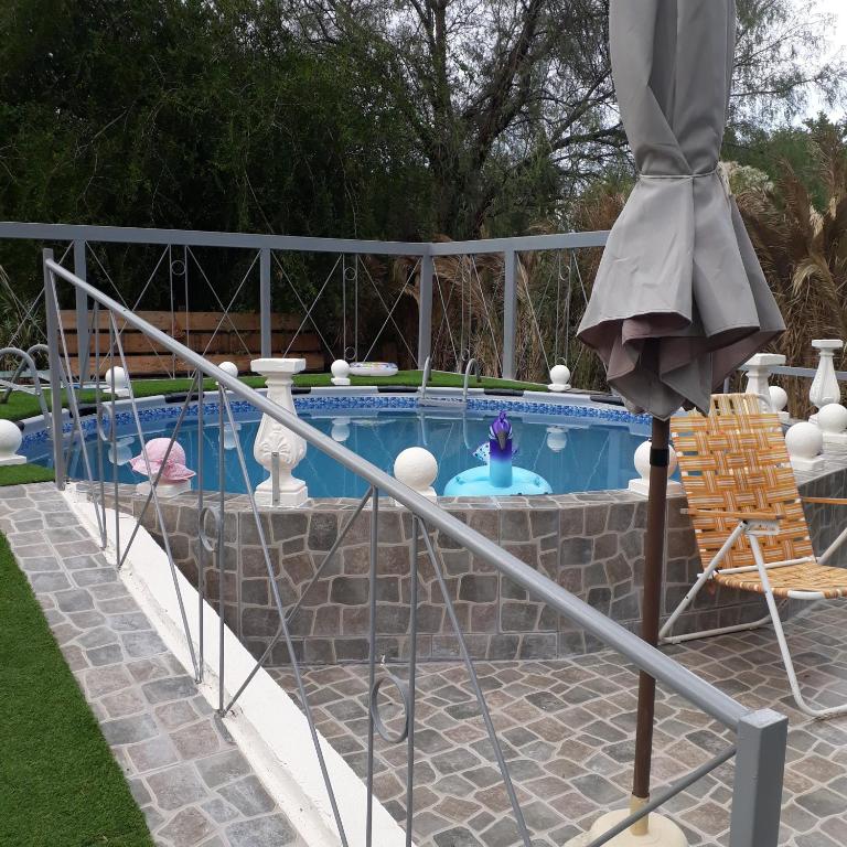 a metal railing next to a swimming pool at Hostería El Zaguan in Cafayate