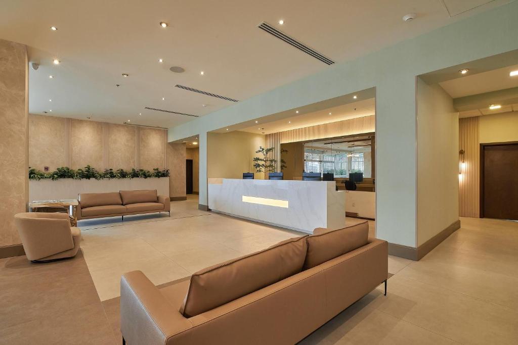 a lobby with couches and a counter in a building at Wyndham Garden Saltillo in Saltillo