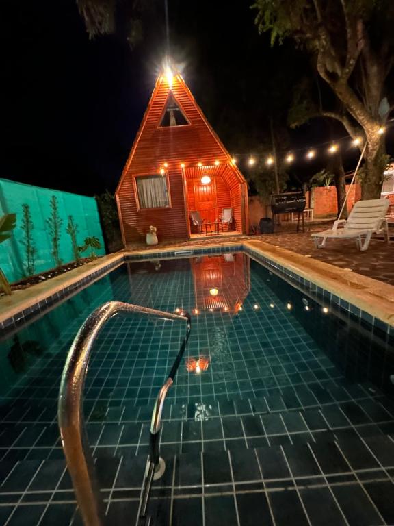 a house with a swimming pool in front of it at Helena Suites in Villarrica