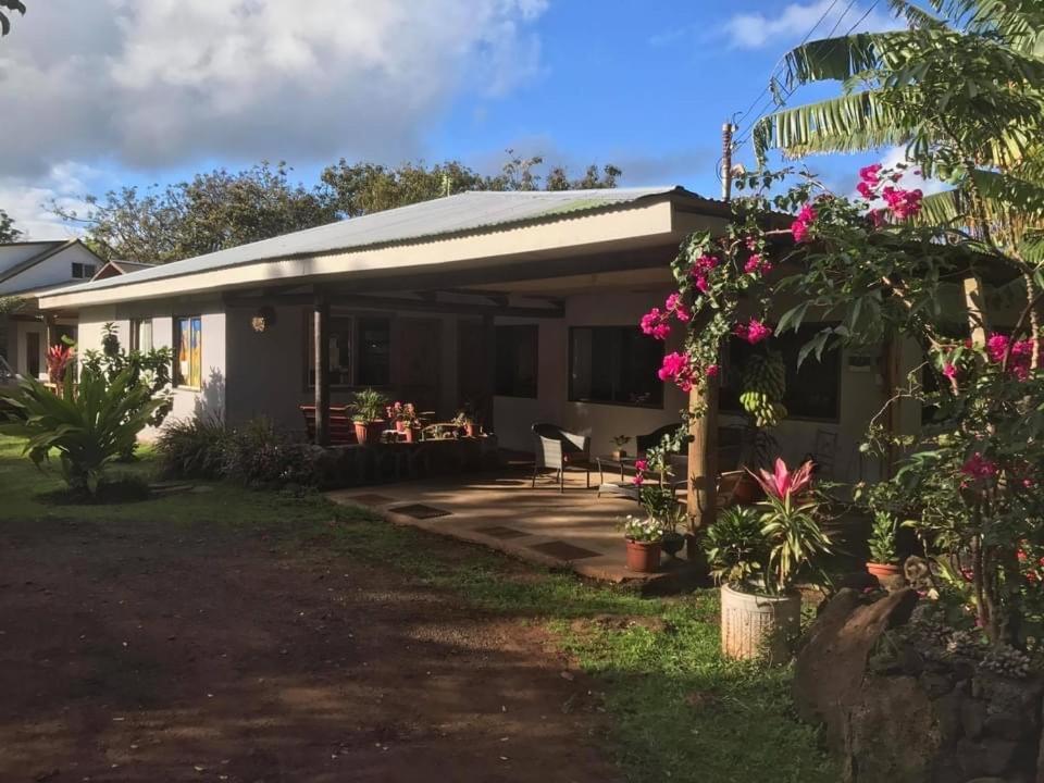 a house with pink flowers in the yard at Pumakari Rapa Nui in Hanga Roa