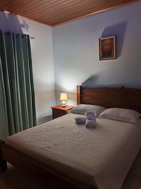 a bedroom with a bed with two towels on it at Yamis home in General Viejo