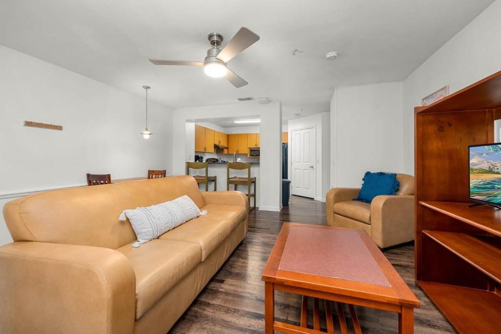 a living room with a couch and a table at 4BD 2 MI to USF Free Pool + 24 Hour Gym in Tampa