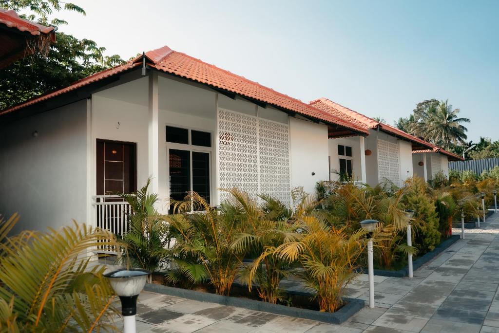 a building with plants in front of it at Fenna Resort And Spa, coorg in Kushālnagar