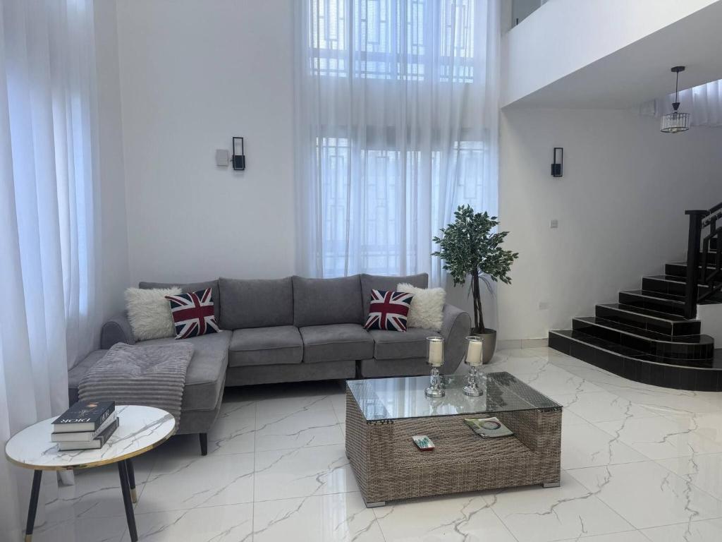 a living room with a couch and a table at Serene 3-Bedroom House in Pridelands, Nairobi in Syokimau