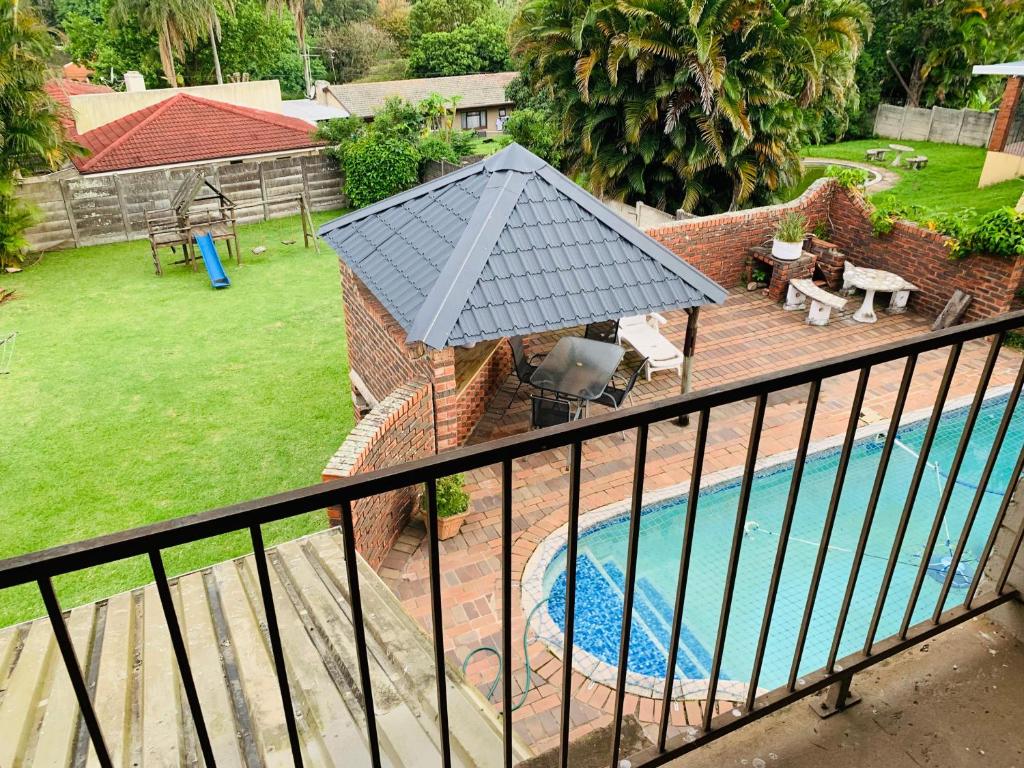 an overhead view of a swimming pool with a roof at Ezendalo Guest House in Pinetown