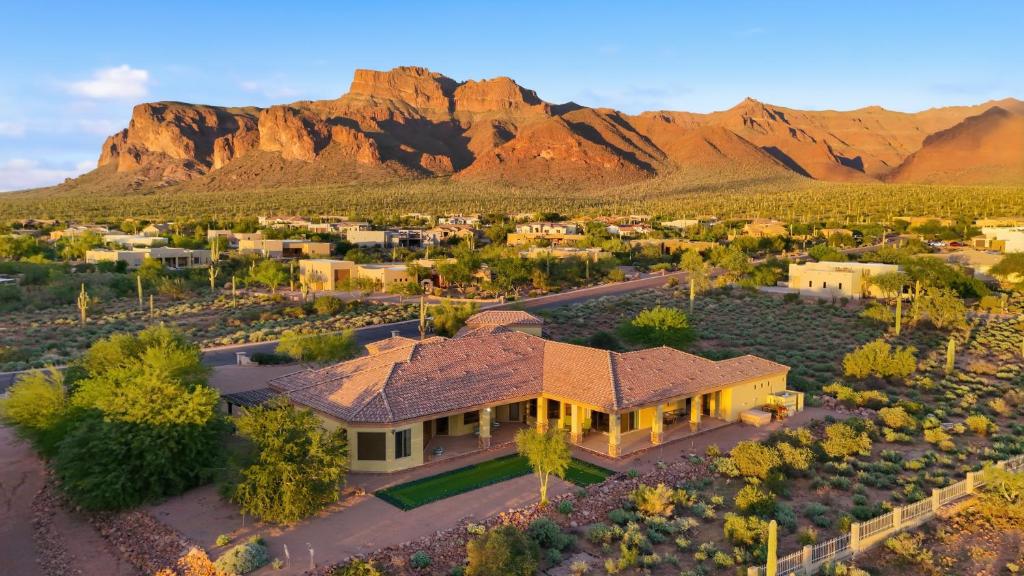 an aerial view of a home with mountains in the background at AUTHENTIC SANTA FE STYLE VILLA WITH PANORAMIC VIEWS in Gold Canyon