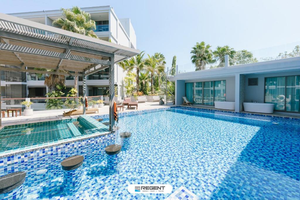 a swimming pool in front of a building at The Regent Phuket Bangtao Beach in Bang Tao Beach