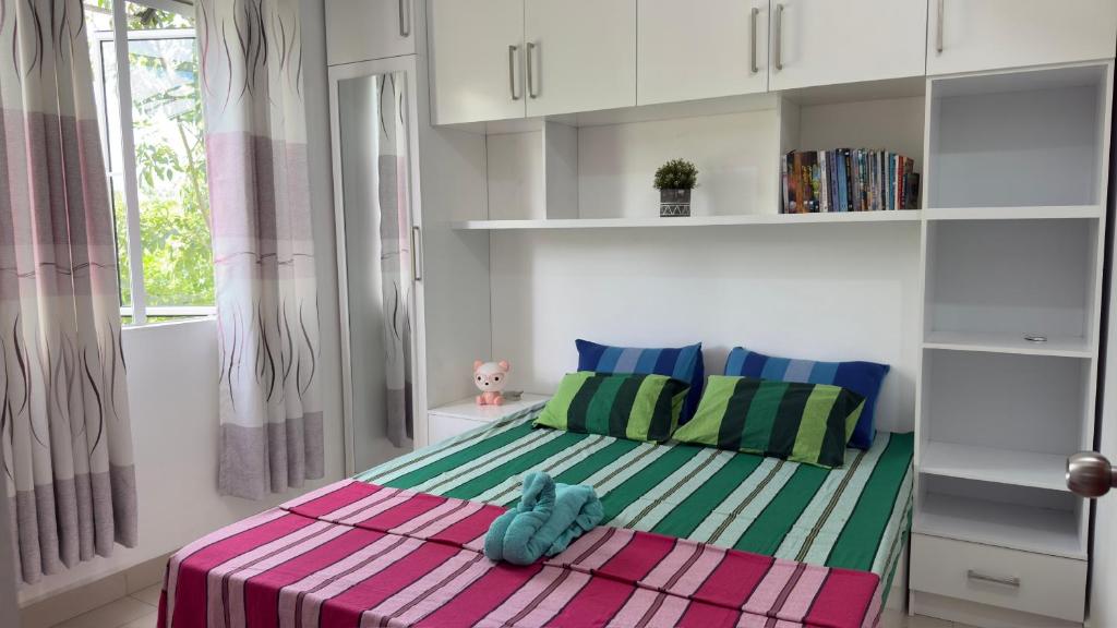 a bedroom with a teddy bear sitting on a bed at Cozy Clifford Homagama in Homagama