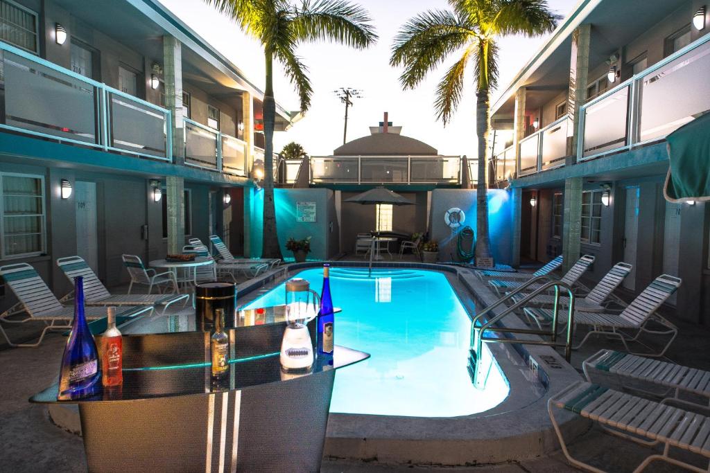 a swimming pool with a bar in a building at Camelot Beach Suites in Clearwater Beach