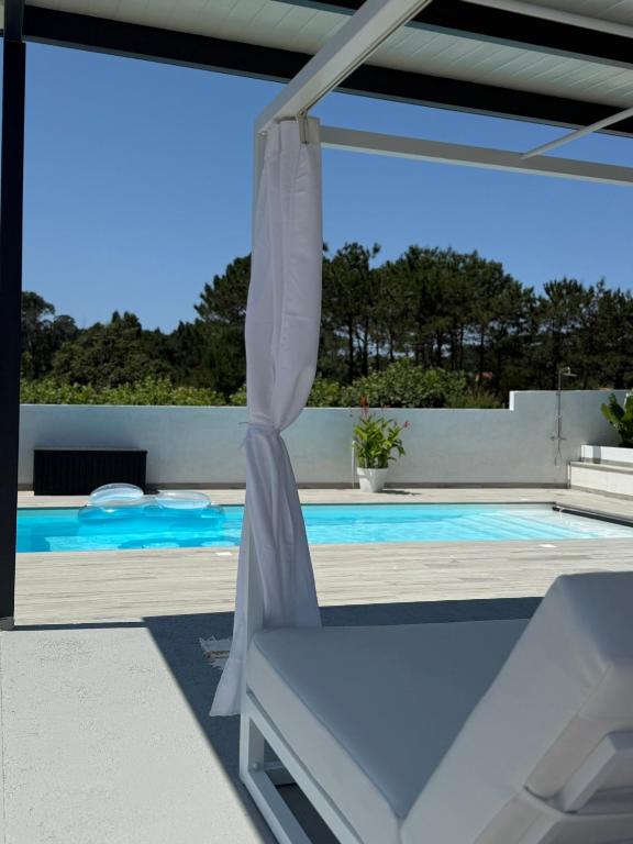 a view of a swimming pool from the patio of a house at Lagarteira in Sanxenxo