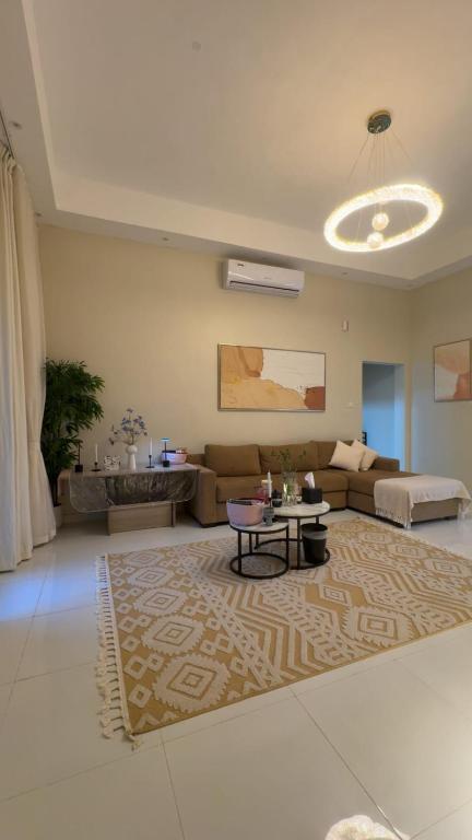 a living room with a couch and a table at The Moonridge Retreat in Sinādil