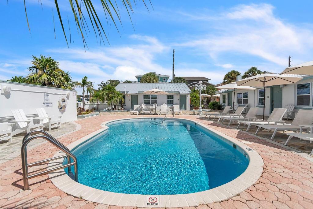 a swimming pool in the backyard of a house at The Bungalows in St. Pete Beach