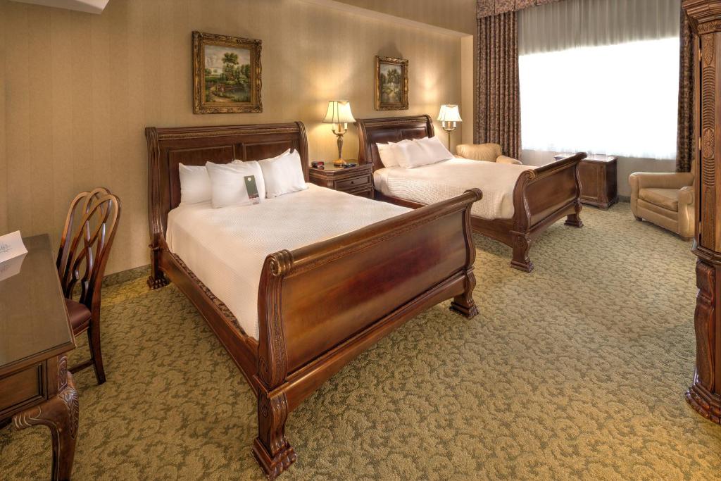 a hotel room with two beds and a chair at Carnegie Hotel & Spa in Johnson City